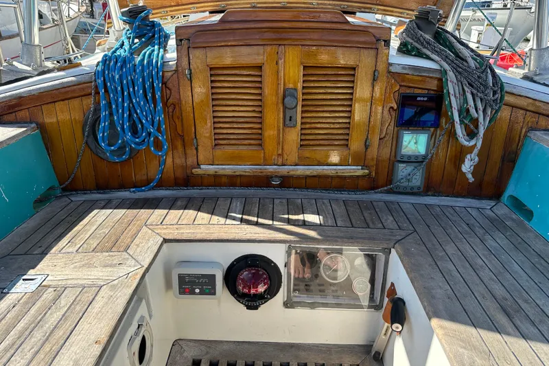 Slide: The Image of Cockpit of 1978 Tayana 37 sailboat with wooden details and nautical equipment. - 18