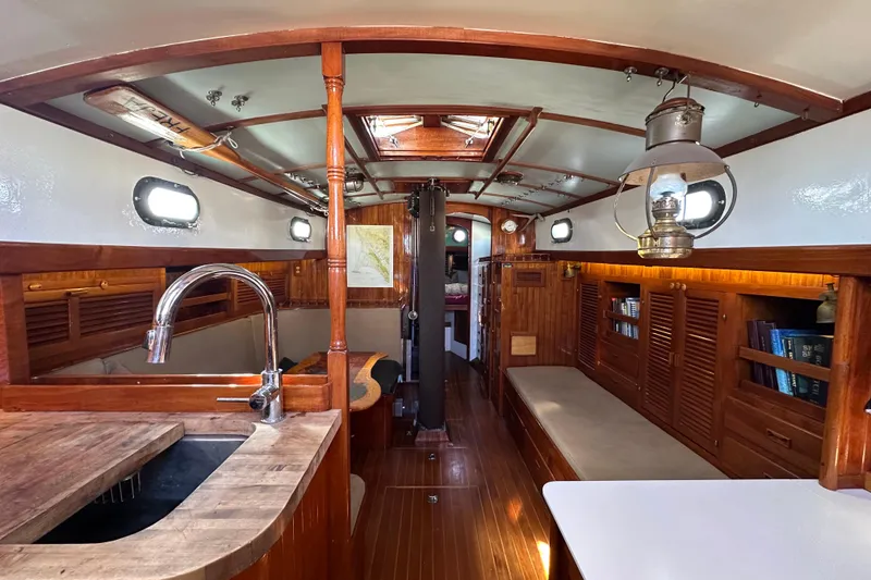 Slide: The Image of Interior of a 1978 Tayana 37 sailboat with wooden finishes and cozy seating. - 20