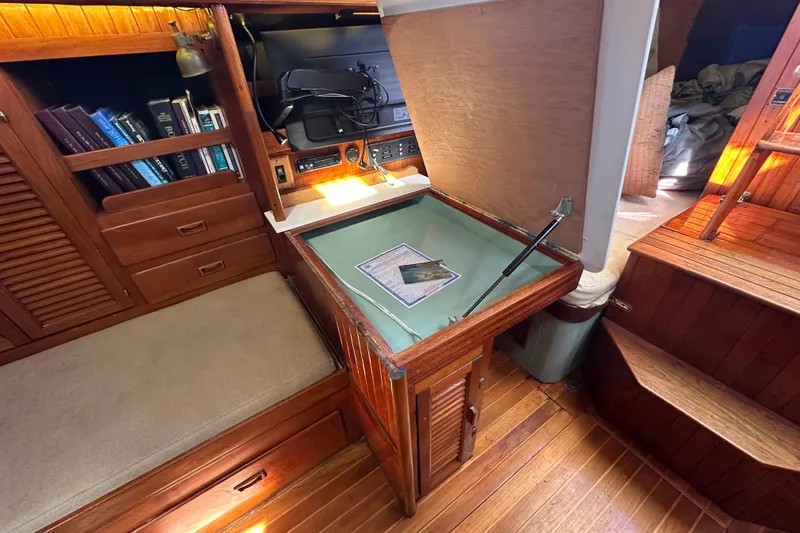 Slide: The Image of Interior of 1978 Tayana 37 sailboat with navigation station and wooden cabinetry. - 25
