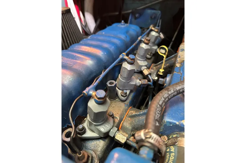 Slide: The Image of Close-up of a 1978 Tayana 37 engine with blue components and visible wiring. - 30
