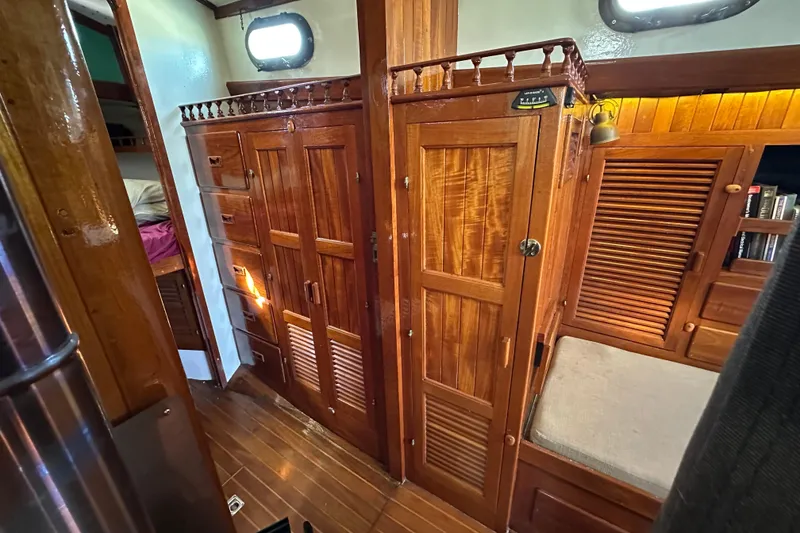 Slide: The Image of Interior of 1978 Tayana 37 sailboat with wooden cabinetry and cozy seating area. - 31