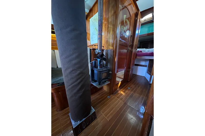 Slide: The Image of Interior of 1978 Tayana 37 sailboat with wood paneling and compact stove. - 32