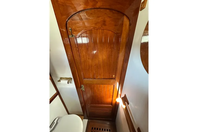Slide: The Image of Wooden door and toilet in 1978 Tayana 37 yacht interior. - 33