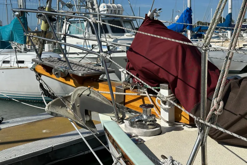 Slide: The Image of 1978 Tayana 37 sailboat bow with anchor and rigging at marina. - 8
