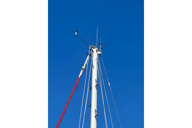 Slide: The Image of Mast of 1978 Tayana 37 sailboat against clear blue sky. - 9