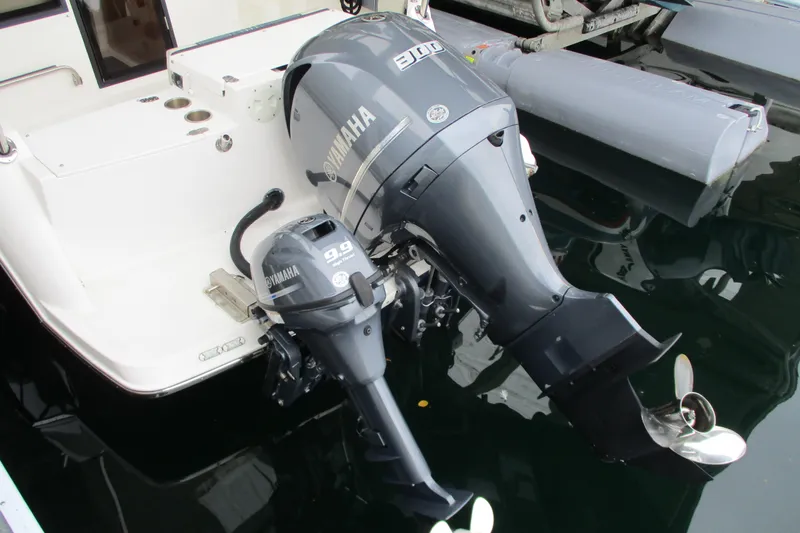 Slide: The Image of 2018 Cutwater C-24 boat with Yamaha outboard motors, docked in a marina. - 11