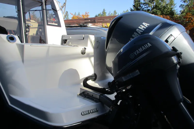 Slide: The Image of 2018 Cutwater C-24 boat with Yamaha outboard motors, docked outdoors. - 13