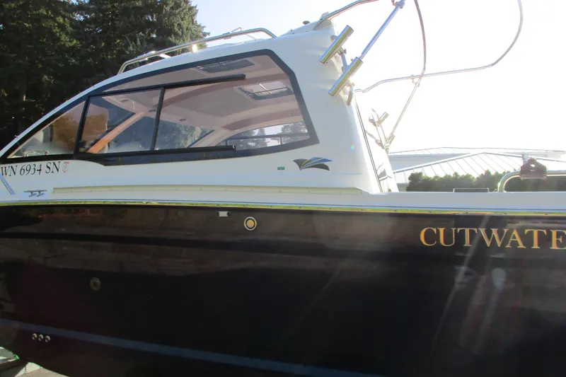 Slide: The Image of 2018 Cutwater C-24 boat with sleek design, docked outdoors. - 17
