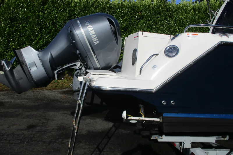 Slide: The Image of 2018 Cutwater C-24 boat with Yamaha outboard motor, parked on a trailer. - 21