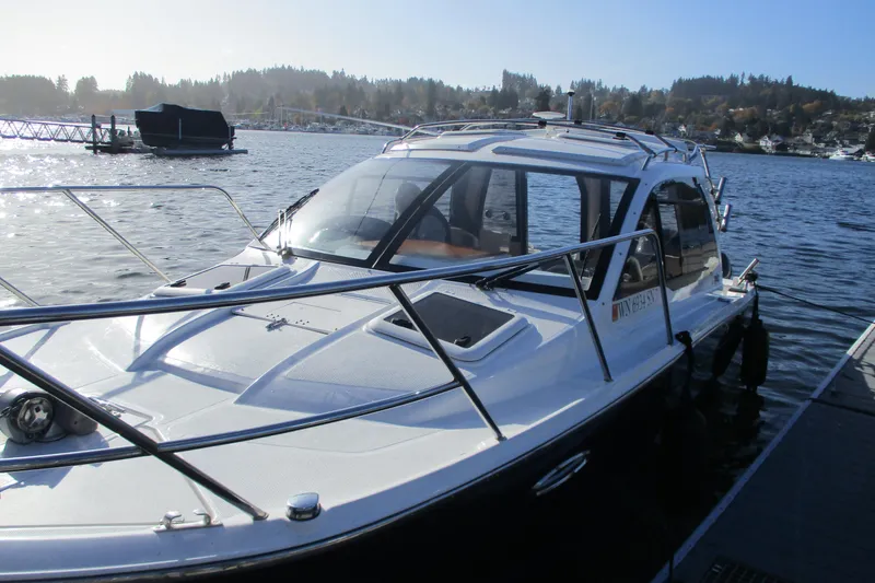 Slide: The Image of 2018 Cutwater C-24 boat docked on a sunny day by the lake. - 22