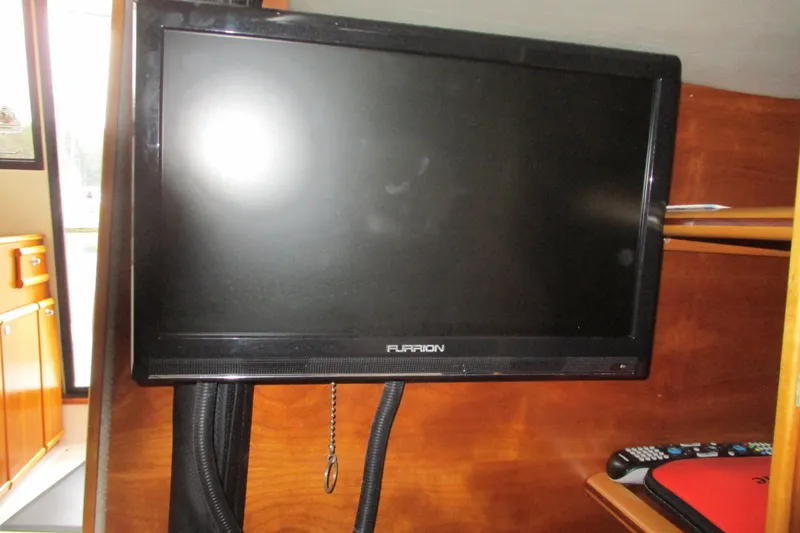 Slide: The Image of Furrion TV inside 2018 Cutwater C-24 boat, mounted on wooden interior. - 35