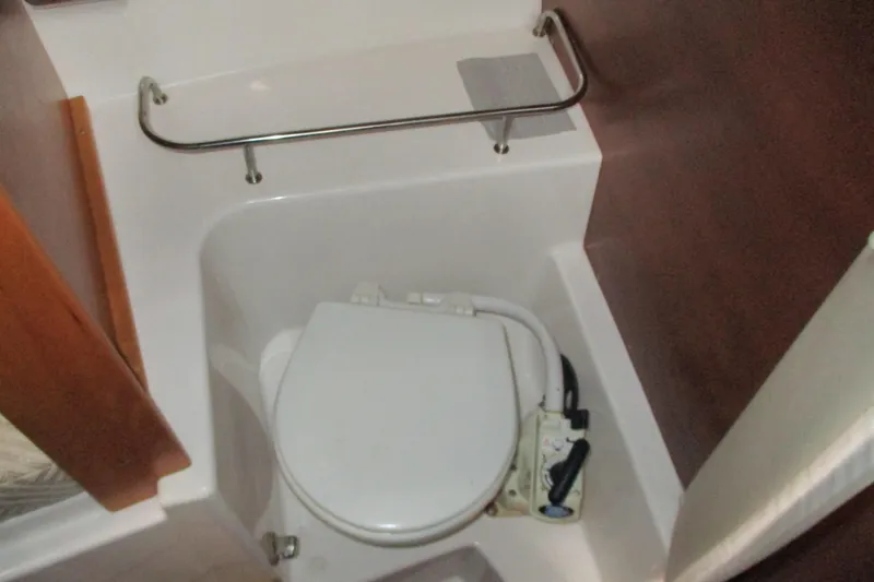 Slide: The Image of 2018 Cutwater C-24 boat bathroom with compact toilet and stainless steel rail. - 38