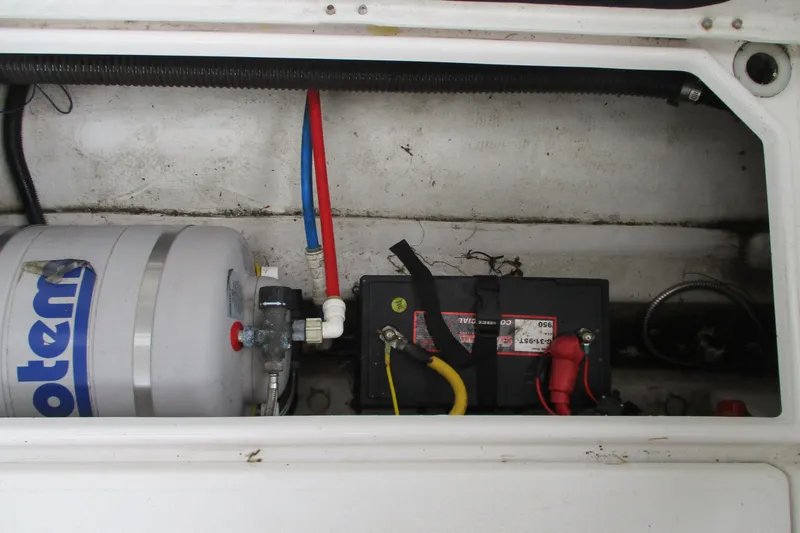 Slide: The Image of 2018 Cutwater C-24 boat compartment with battery and water heater system. - 39