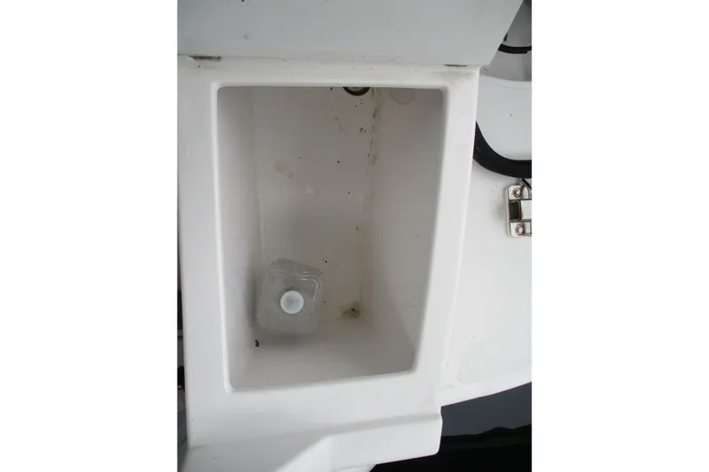 Slide: The Image of Storage compartment on 2018 Cutwater C-24 boat with a plastic bottle inside. - 43