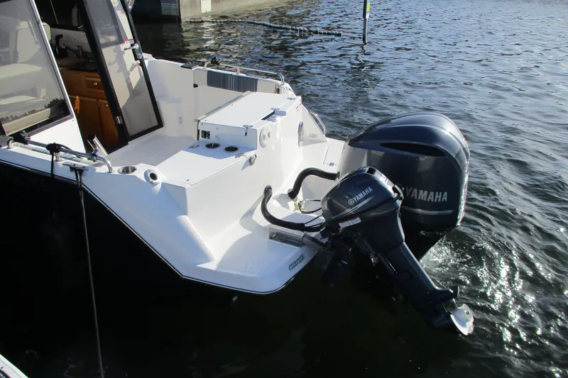 Slide: The Image of 2018 Cutwater C-24 boat with Yamaha outboard motor, docked on calm water. - 6