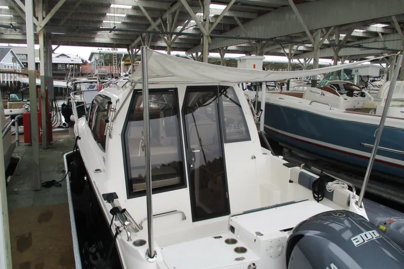 Slide: The Image of 2018 Cutwater C-24 boat docked under a covered marina, showcasing its sleek design. - 8