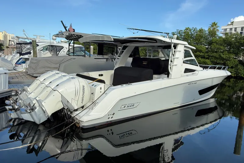 The Image of 2020 Boston Whaler 420 Outrage boat docked with multiple Mercury engines. - 0