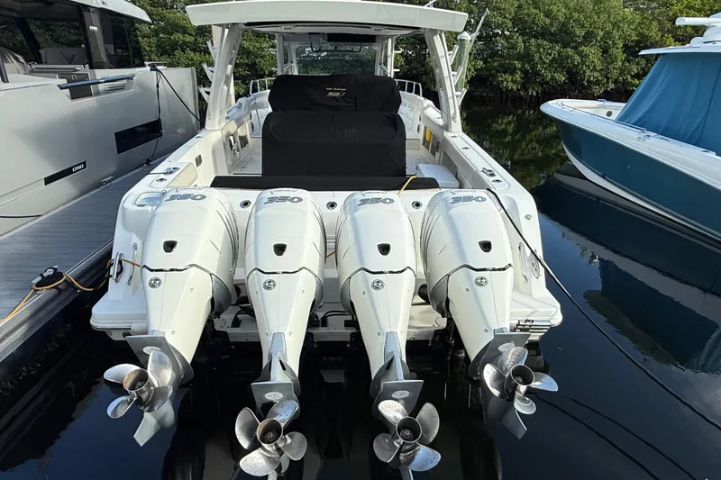 Slide: The Image of 2020 Boston Whaler 420 Outrage with four powerful outboard engines docked at marina. - 2