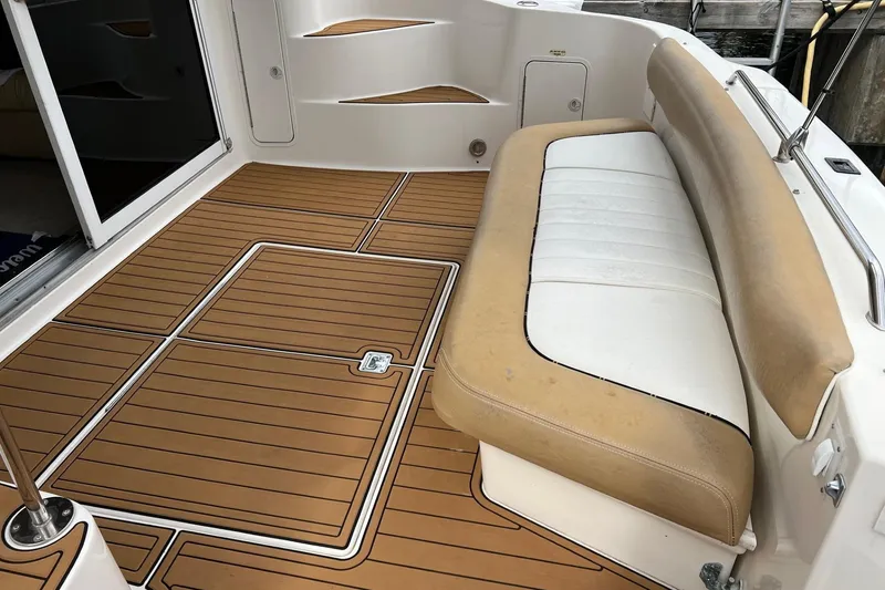 Slide: The Image of 2000 Sea Ray 400 Sedan Bridge deck with tan and white seating. - 14
