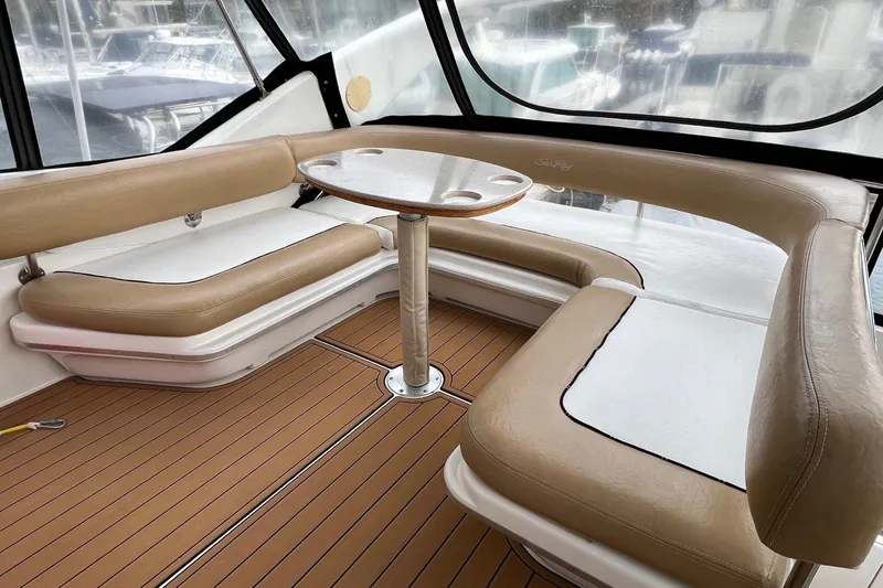 Slide: The Image of Luxurious seating area on 2000 Sea Ray 400 Sedan Bridge yacht with tan upholstery and wooden flooring. - 22