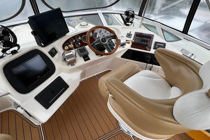 Slide: The Image of Cockpit of 2000 Sea Ray 400 Sedan Bridge with leather seat and modern controls. - 23