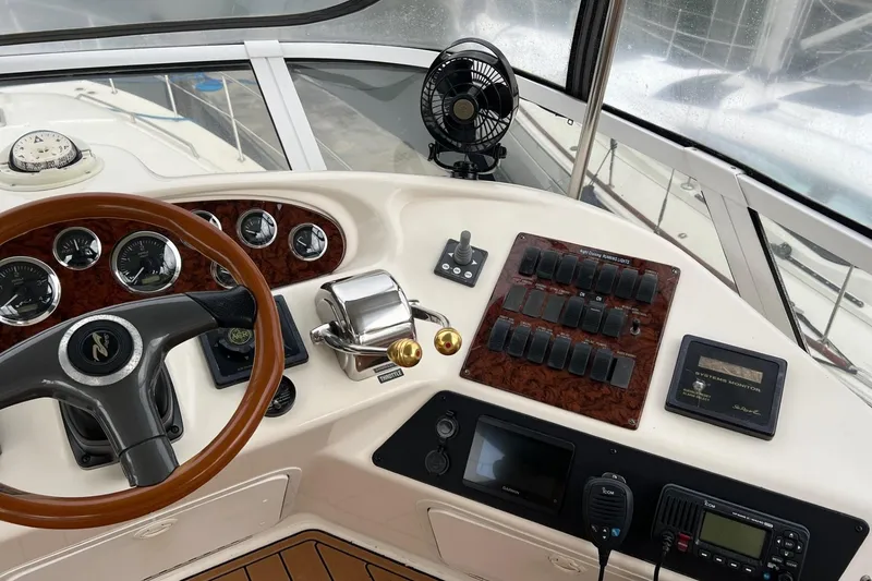 Slide: The Image of Cockpit of 2000 Sea Ray 400 Sedan Bridge with steering wheel and control panel. - 25