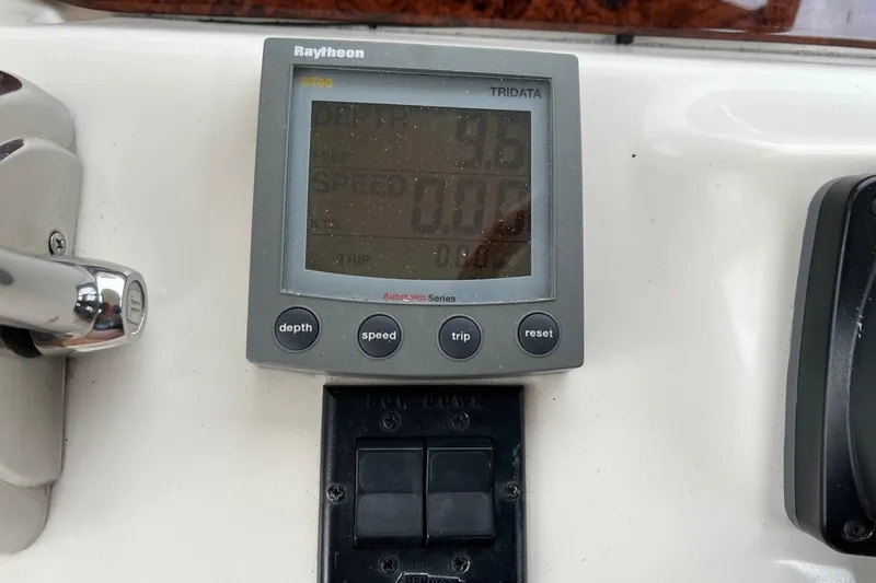 Slide: The Image of Raytheon ST60 Tridata display on 2000 Sea Ray 400 Sedan Bridge dashboard. - 28