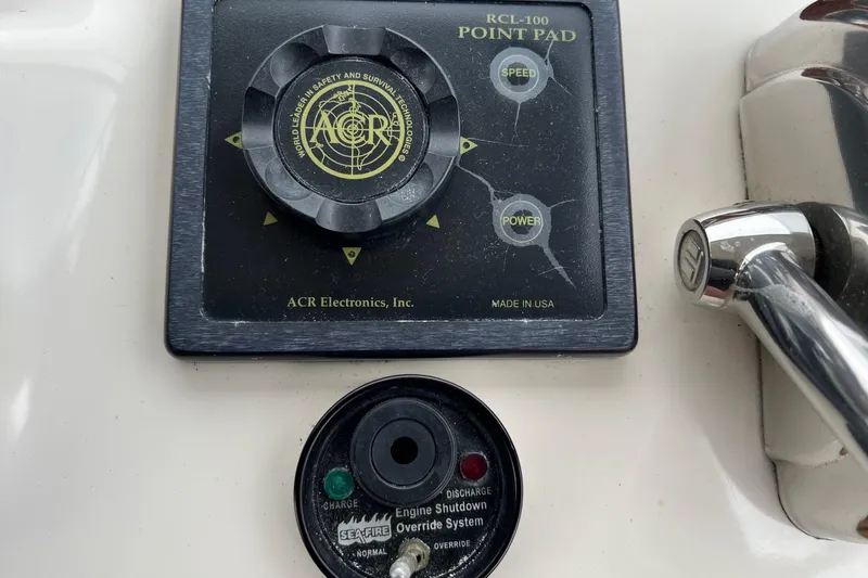 Slide: The Image of Control panel on 2000 Sea Ray 400 Sedan Bridge with ACR Electronics and Sea-Fire systems. - 29