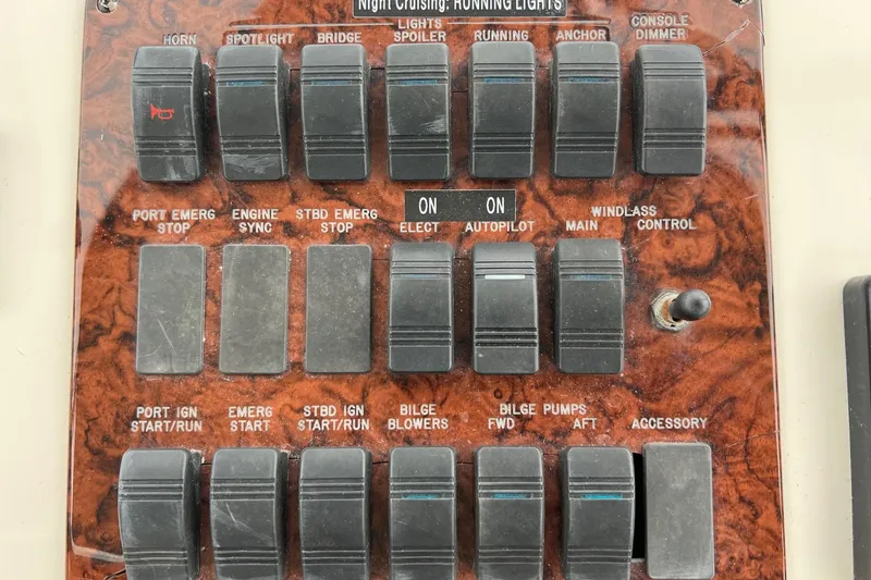 Slide: The Image of Control panel of a 2000 Sea Ray 400 Sedan Bridge with labeled switches and toggles. - 31