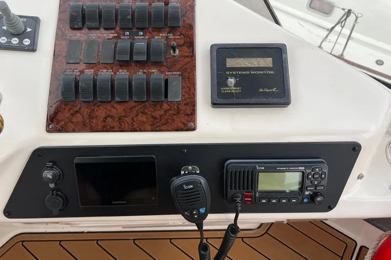 Slide: The Image of Control panel of a 2000 Sea Ray 400 Sedan Bridge with switches and systems monitor. - 33