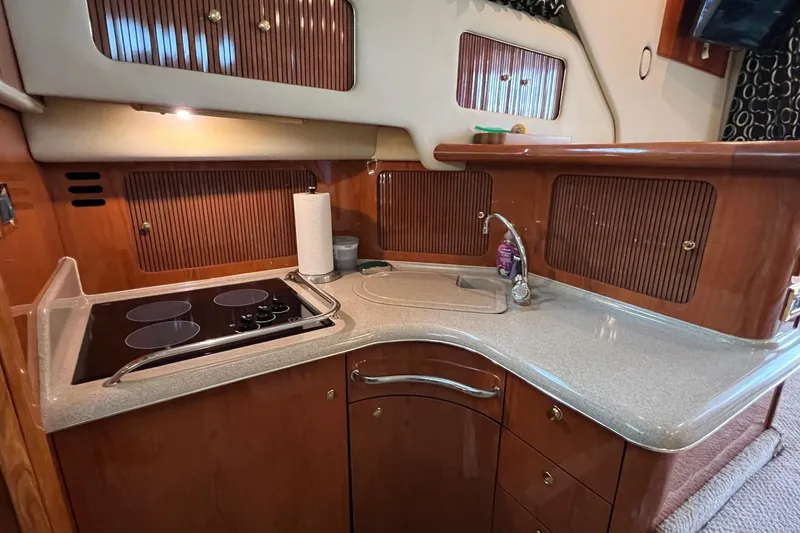 Slide: The Image of Galley kitchen in 2000 Sea Ray 400 Sedan Bridge yacht with stove and sink. - 46