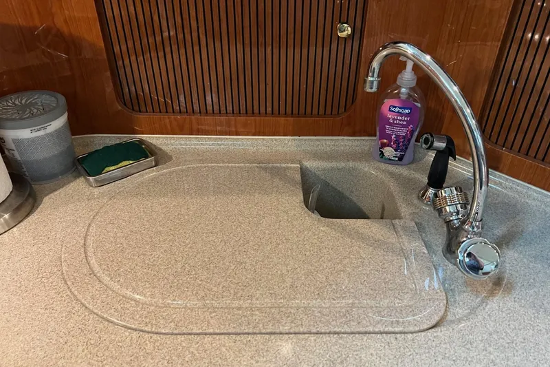 Slide: The Image of Kitchen sink area on a 2000 Sea Ray 400 Sedan Bridge yacht. - 47