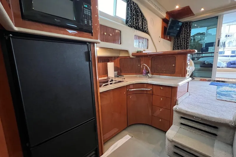 Slide: The Image of Interior of 2000 Sea Ray 400 Sedan Bridge yacht with kitchen and seating area. - 49