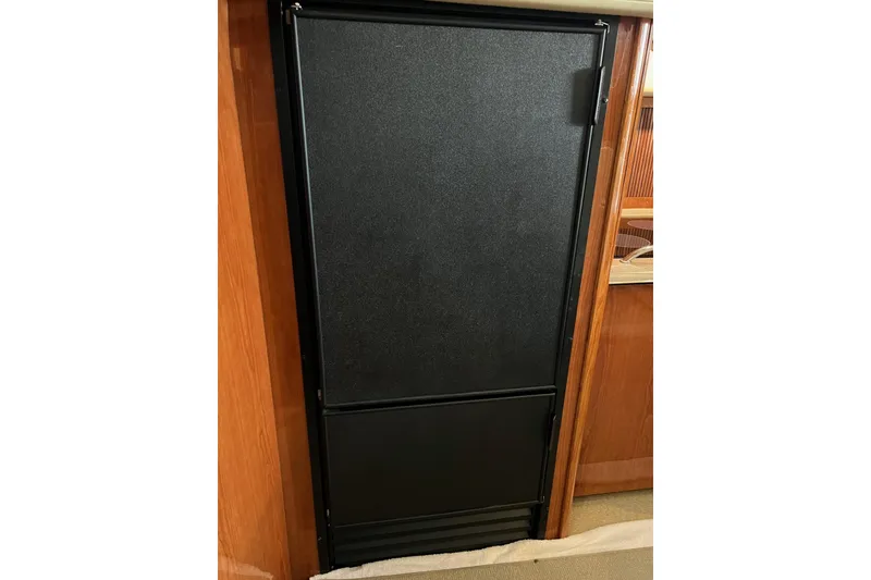 Slide: The Image of Black refrigerator door inside 2000 Sea Ray 400 Sedan Bridge yacht. - 50