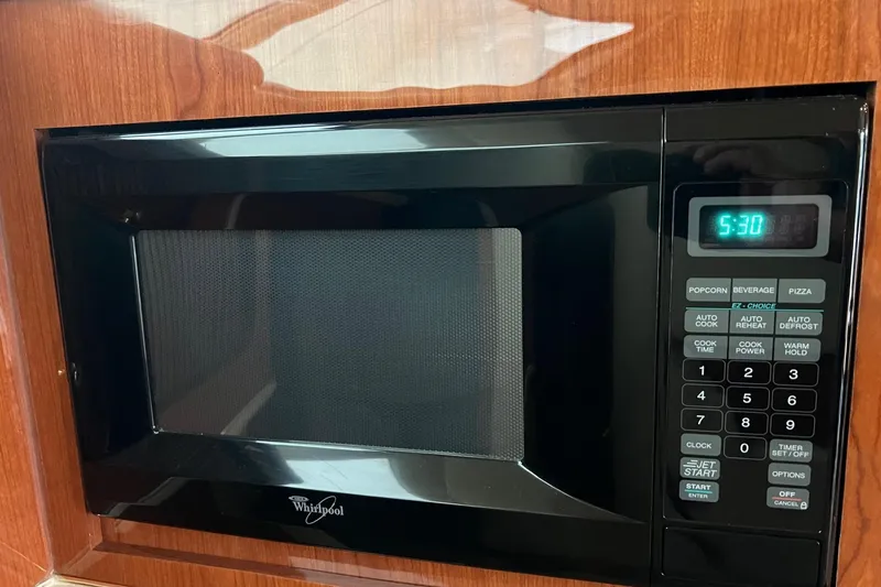 Slide: The Image of Whirlpool microwave in 2000 Sea Ray 400 Sedan Bridge yacht kitchen, displaying 5:30. - 51