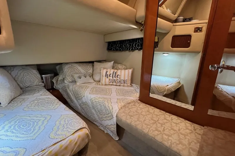 Slide: The Image of 2000 Sea Ray 400 Sedan Bridge cabin with cozy twin beds and decorative pillows. - 53