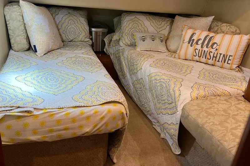 Slide: The Image of Cozy twin beds in 2000 Sea Ray 400 Sedan Bridge cabin with decorative pillows. - 54
