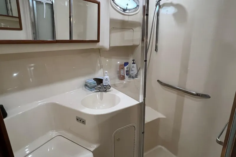 Slide: The Image of Bathroom interior of 2000 Sea Ray 400 Sedan Bridge yacht, featuring sink and shower. - 57