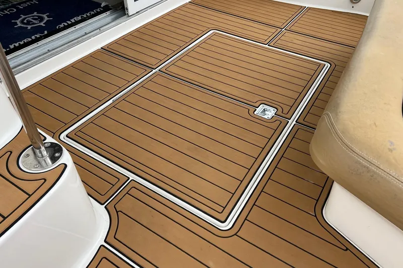 Slide: The Image of Teak deck of 2000 Sea Ray 400 Sedan Bridge yacht, featuring a hatch and beige seating. - 59