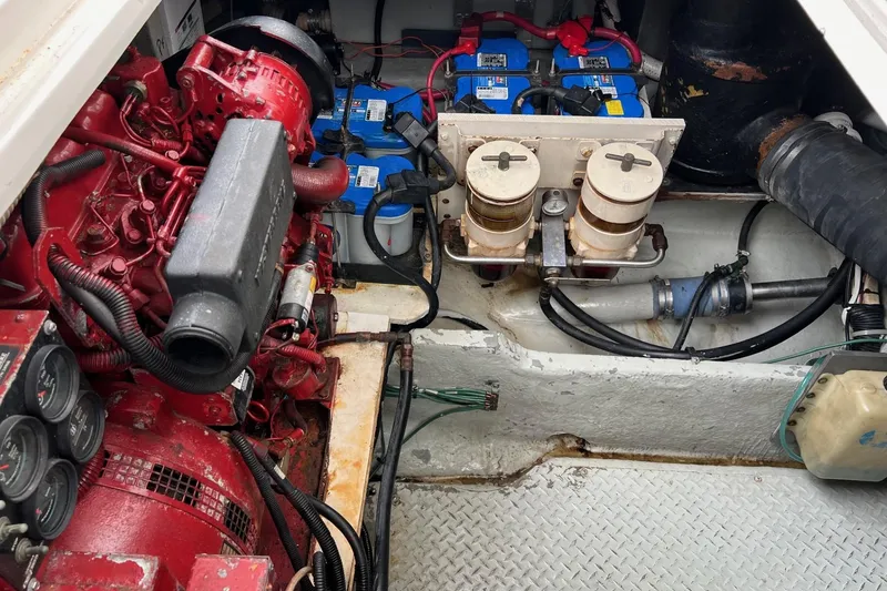Slide: The Image of Engine room of 2000 Sea Ray 400 Sedan Bridge with visible components and batteries. - 61