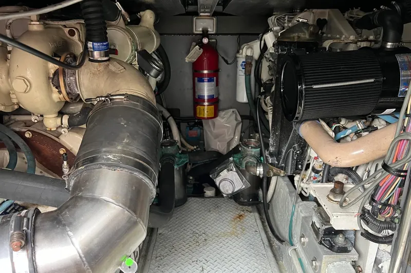 Slide: The Image of Engine room of a 2000 Sea Ray 400 Sedan Bridge with visible components and fire extinguisher. - 66