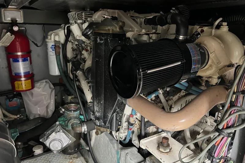 Slide: The Image of Engine room of a 2000 Sea Ray 400 Sedan Bridge with visible components and fire extinguisher. - 68