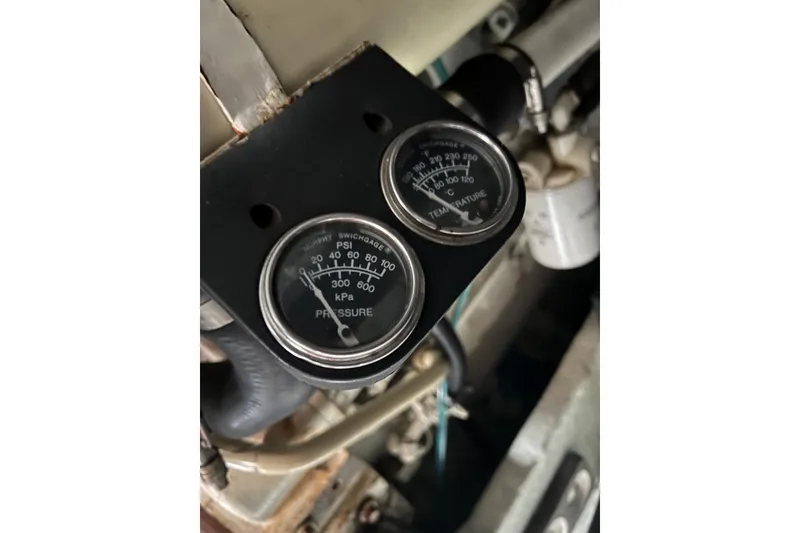 Slide: The Image of Close-up of pressure and temperature gauges on a 2000 Sea Ray 400 Sedan Bridge. - 69