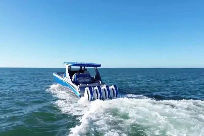 Slide: The Image of 2023 Mystic Powerboats M3800 cruising on open water, showcasing powerful engines and sleek design. - 10