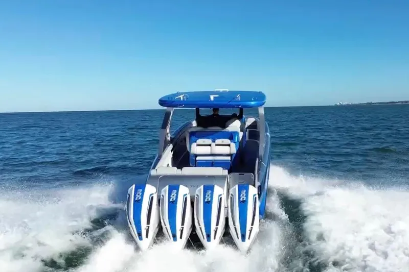 Slide: The Image of 2023 Mystic Powerboats M3800 cruising on open water, showcasing powerful engines. - 12