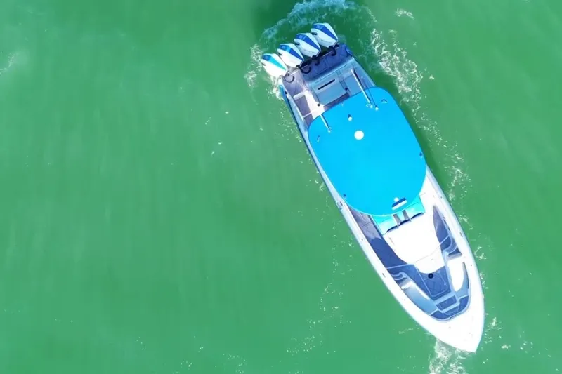 Slide: The Image of Aerial view of 2023 Mystic Powerboats M3800 cruising on green water. - 15