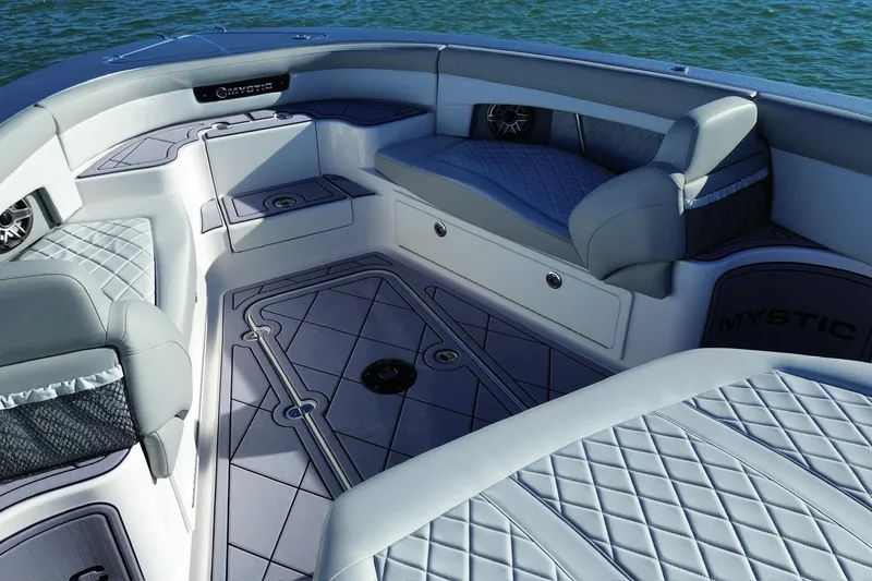 Slide: The Image of 2023 Mystic Powerboats M3800 interior with luxurious seating and elegant design on the water. - 20