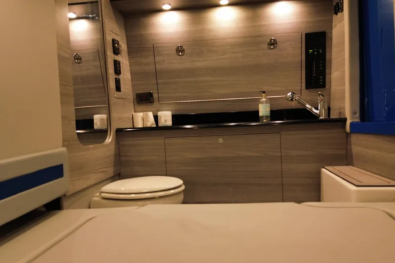 Slide: The Image of Luxurious 2023 Mystic Powerboats M3800 interior bathroom with modern fixtures and ambient lighting. - 27
