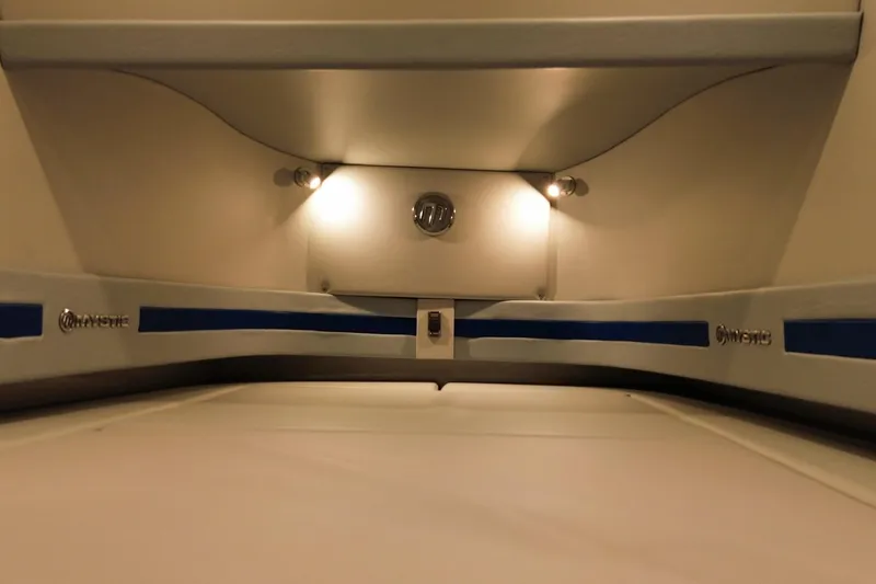 Slide: The Image of Interior cabin of 2023 Mystic Powerboats M3800 with ambient lighting and sleek design. - 29