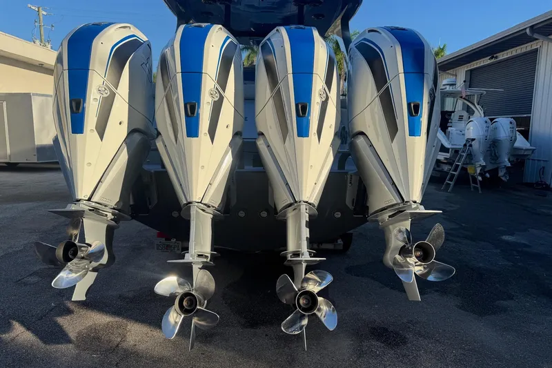 Slide: The Image of 2023 Mystic Powerboats M3800 with four powerful outboard engines, rear view. - 35